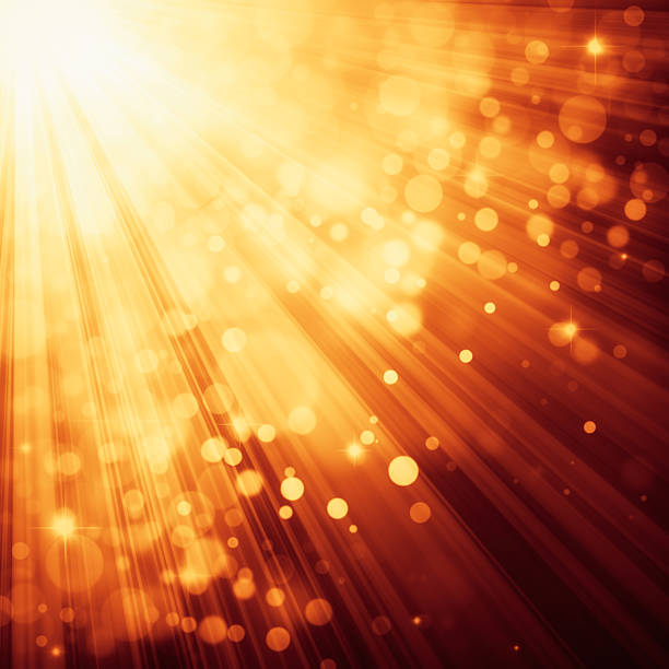 istock Yellow rays of light with bubbles and glitters 491242042