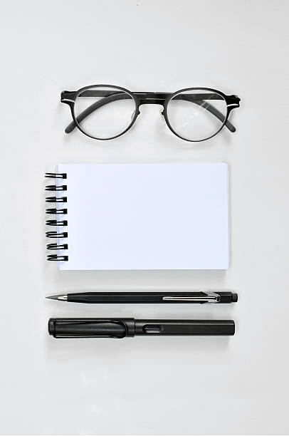 istock Eye glasses, blank notepad, pen, and mechanical pencil 491243355