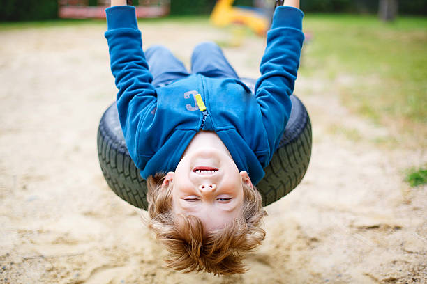 istock Little kid boy having fun on swing in summer 491243496