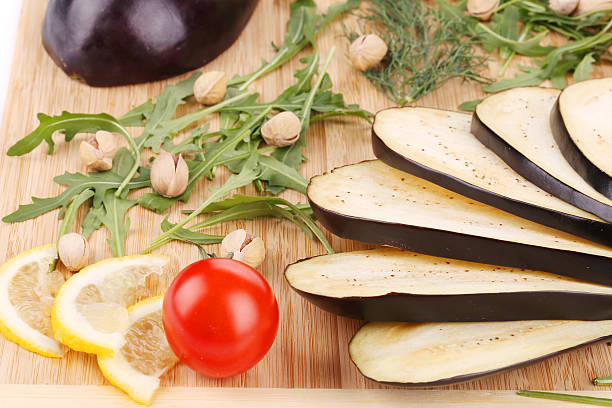 istock Close up of eggplant on wooden platter. 491243721