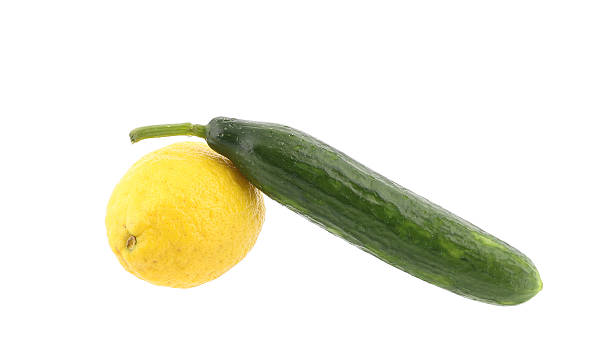 istock Yellow lemon with green cucumber. 491243769