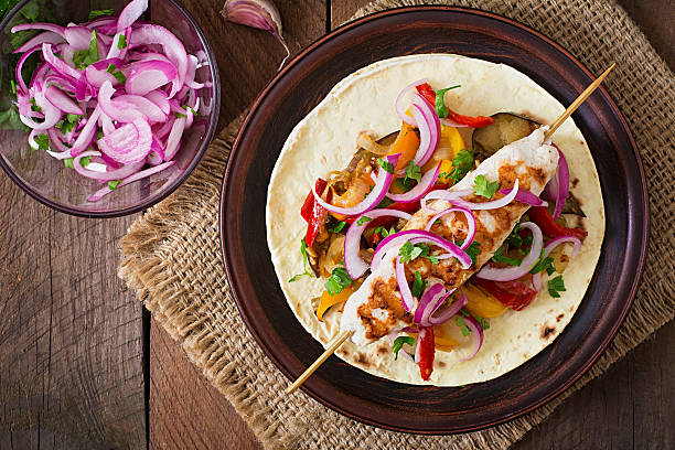 istock Chicken kebab with grilled vegetables and tortilla wrap. 491244502