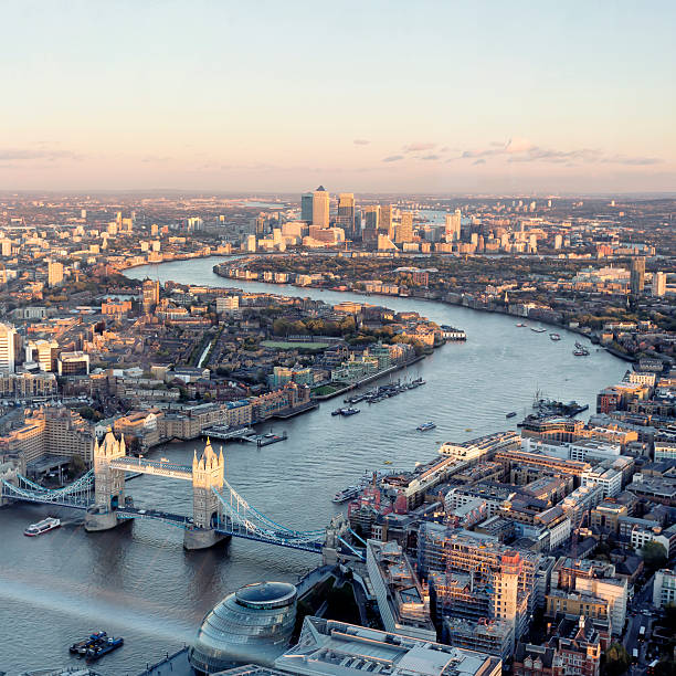 High angle view of London skyline at sunset London aerial cityscape with landmarks including the Thames, Canary Wharf, Tower Bridge and City Hall. railway bridge photos stock pictures, royalty-free photos & images