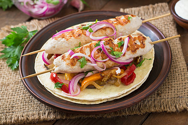 istock Chicken kebab with grilled vegetables and tortilla wrap. 491244836