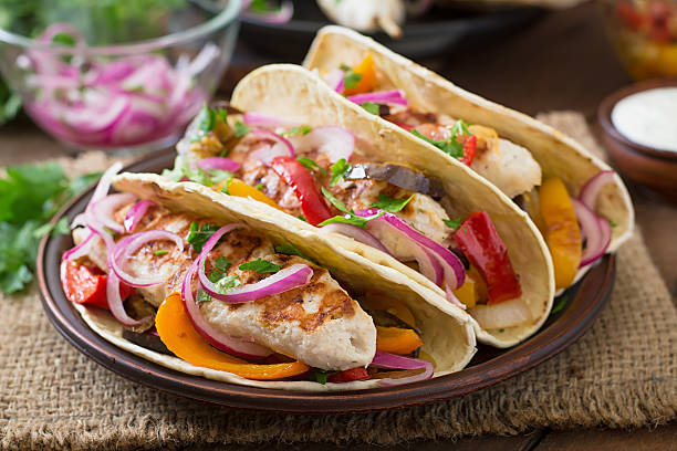 istock Mexican tacos with chicken, grilled vegetables and red onion. 491244874