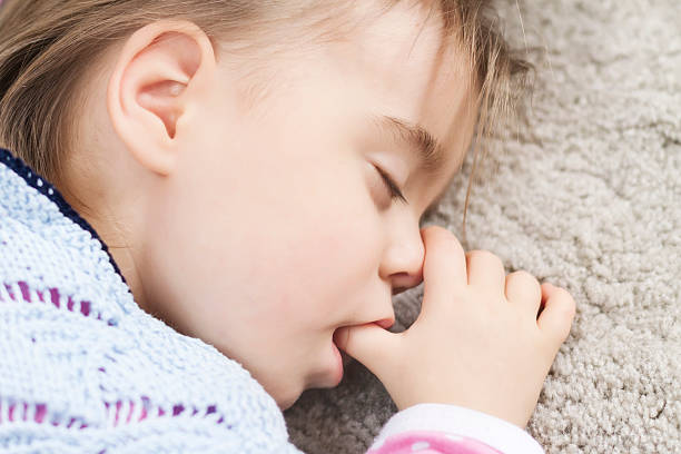 istock Cute child sleeping and sucking thumb 491244915