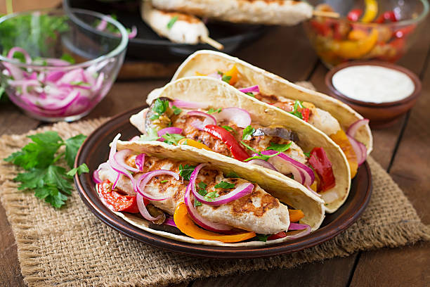istock Mexican tacos with chicken, grilled vegetables and red onion. 491244940