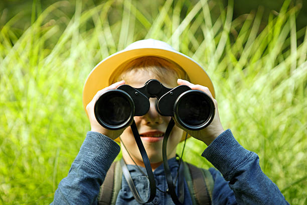 istock Child in Safari Hat Looking Through Big Binoculars 491244942