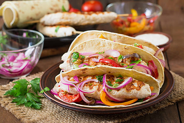 istock Mexican tacos with chicken, grilled vegetables and red onion. 491245038