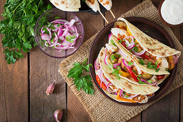 istock Mexican tacos with chicken, grilled vegetables and red onion. 491245148