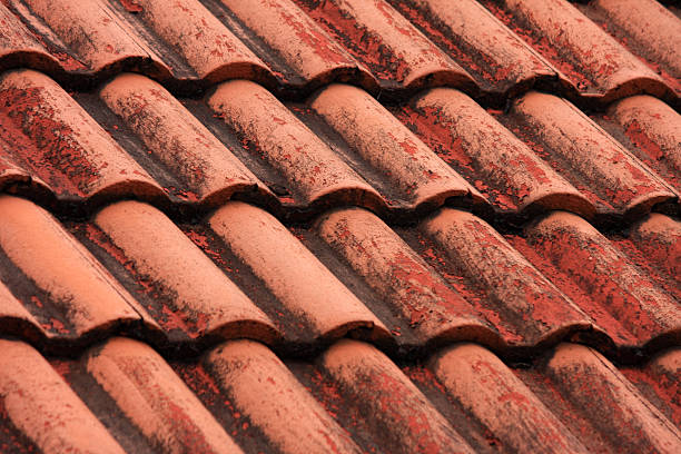 istock old roof tiles with blue sky background. 491245256