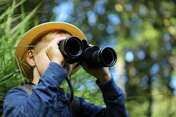 istock Child Looking Through Big Binoculars Outdoors 491245294