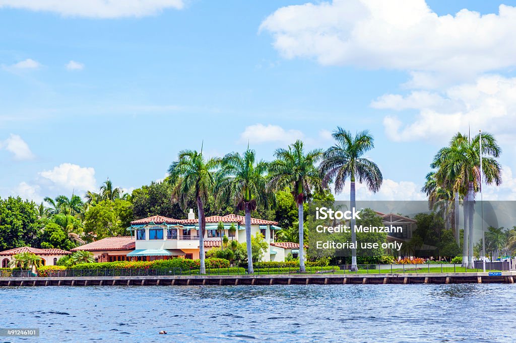 view to beautiful houses from the canal in Fort Lauderdale Fort Lauderdale, USA - August 1, 2010: Luxurious waterfront home in Fort Lauderdale. There are 165 miles  of waterways within the city limits and 9,8 percent of the city is covered by water. Apartment Stock Photo