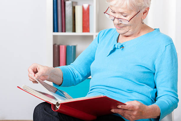 istock Elderly woman watching photos 491247211