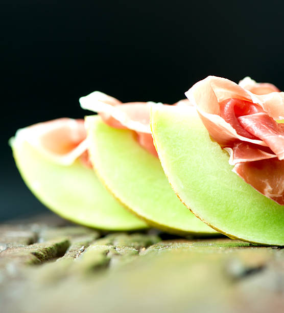 istock Serrano ham with melon on old wooden table three 491247321