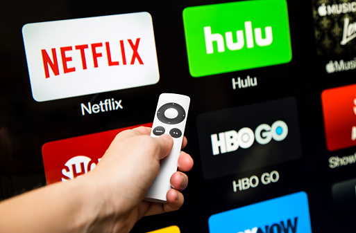 Canton, GA, USA - October 4, 2015 Netflix, hulu, and hbo subscription streaming video service accessed through a Apple tv and displayed on a hd tv.  These application are paid services popular with cable cutters as an alternative to paying for cable.  