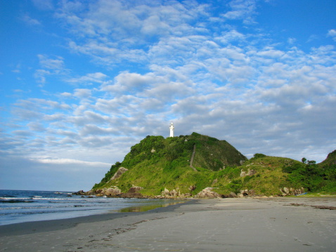 Wild beach and lighthouse at Ilha do Mel (Honey Island) near Curitiba, Brasil.