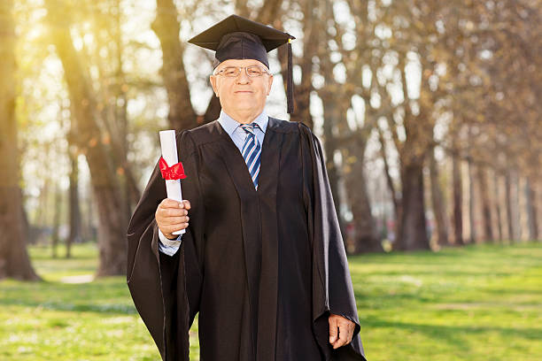 istock Proud mature student holding a diploma in park 491247877