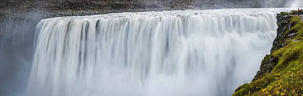 Photo of Thundering waterfall rushing through rocky canyon Dettifoss landmark panorama Iceland