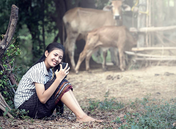 Thai Young Woman Holding Radio in farm stock photo