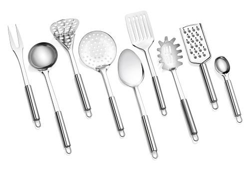 Kitchen utensil set standing against white background