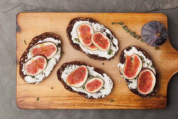 istock Bread with fresh cheese, fig and sprig of thyme 491248852