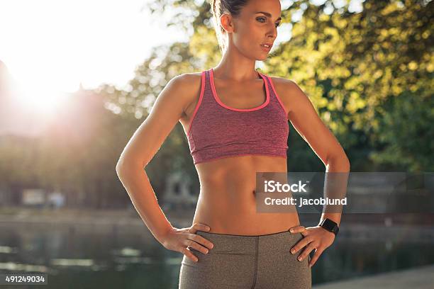 Woman Takes A Break After Running Stock Photo - Download Image Now - Abdomen, Women, Exercising