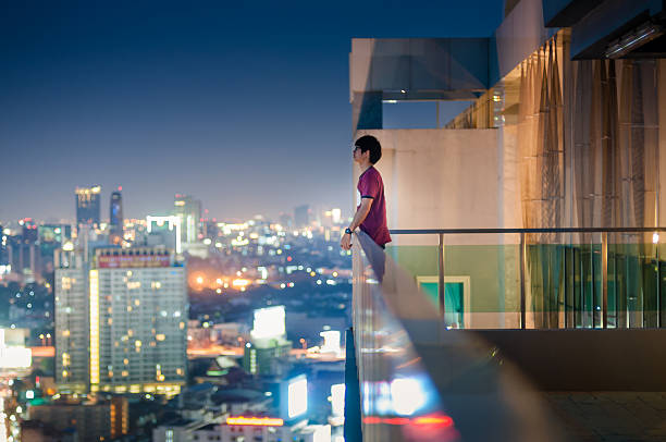 istock Men standing on the rooftop of a skyscraper over  cityscape 491267820