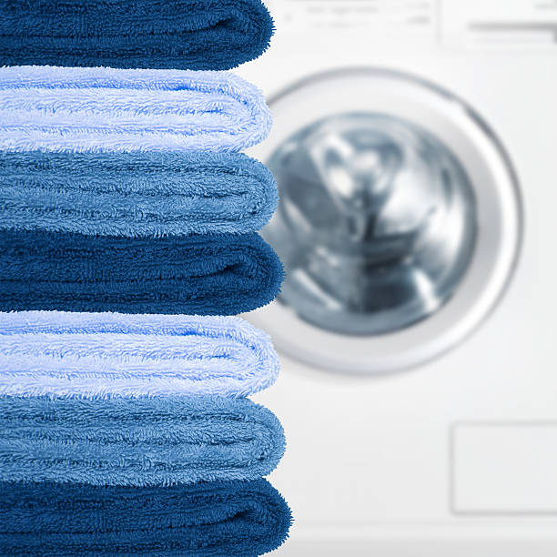 istock Pile of clean towels with washing machine 491267840