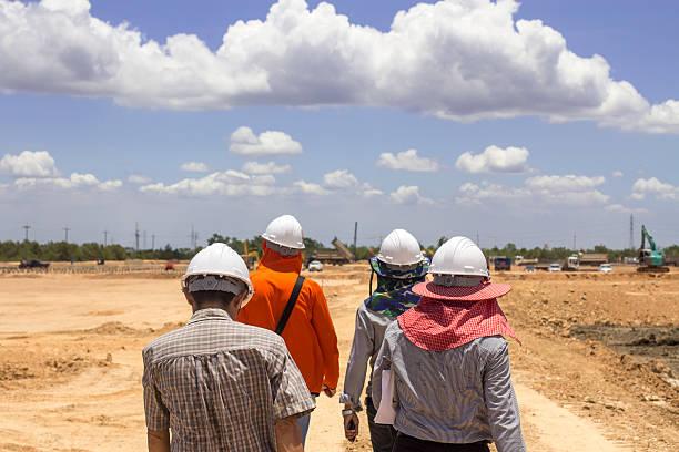 Project management team walking on construstion site stock photo