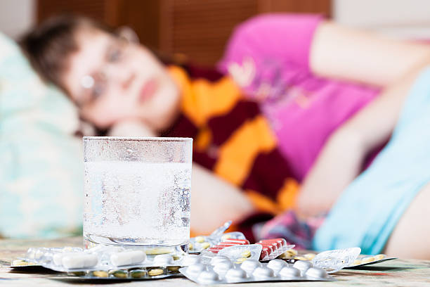istock glass with dissolved drug in water and pills 491277422