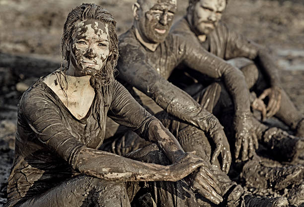 istock group of people relaxing after mud obstacle run 491277814