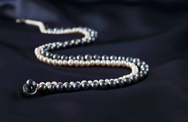 istock pearl necklaces on a dark blue background 491278166