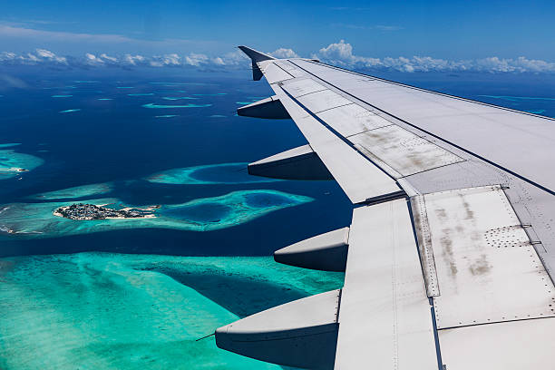 Arplane fly over Atolls stock photo