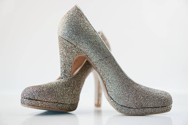 istock Womens golden high heels on white background 491278428