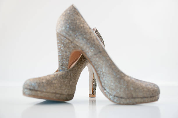istock Womens golden high heels on white background 491278458