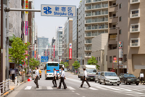 Tokyo, Japan - May 15, 2015: Pedestrians walking over a street crossing on the border between the Shinjuku and Shibuya districts of Tokyo.