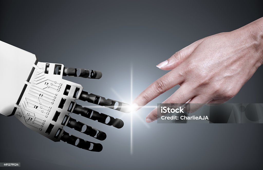 Robot human hand connection Robot and human touching forefingers 2015 Stock Photo