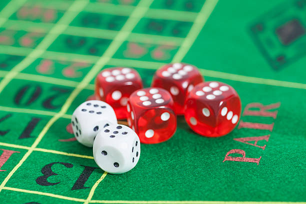 istock roll  red and white dice on  game table in  casino 491279188