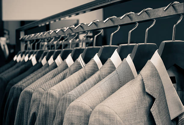 wood hanger with light grey suit isolated on grey background
