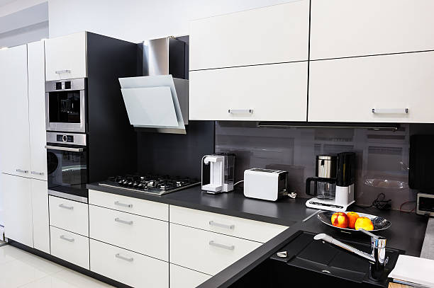 Modern hi-tek kitchen, clean interior design Modern luxury hi-tek black and white kitchen interior, clean design coffee maker in kitchen stock pictures, royalty-free photos & images