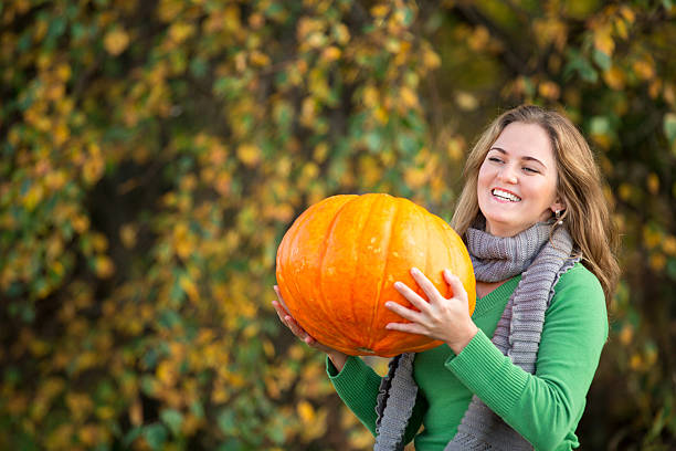 istock Girl with pumpkin 491282906