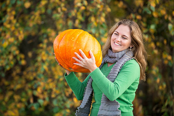 istock Girl with pumpkin 491282988