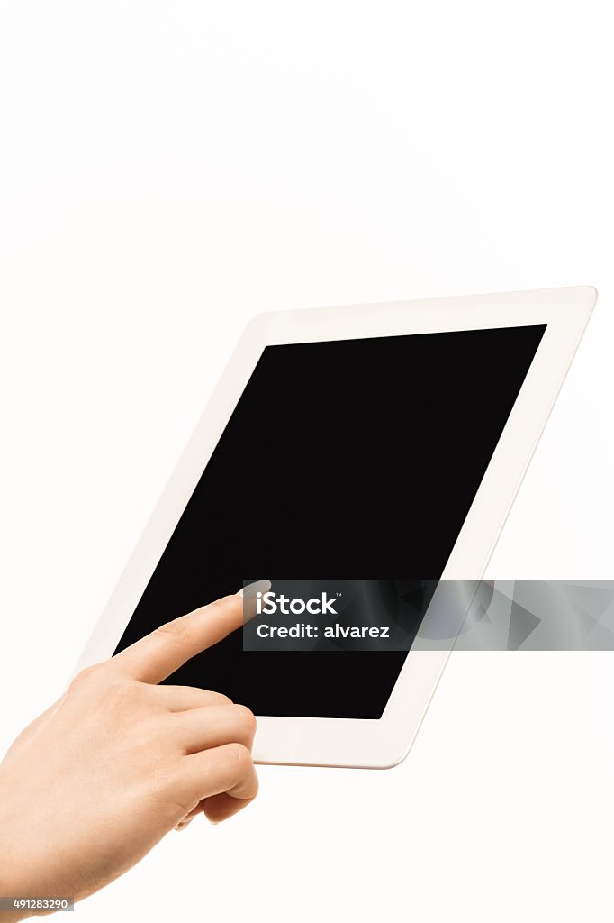 Woman using digital tablet Closeup shot of woman finger touching the blank screen of a digital tablet computer isolated on white background 2015 Stock Photo