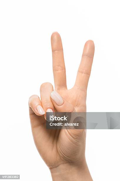 Hand Gesturing Peace Symbol Stock Photo - Download Image Now - Peace Sign - Gesture, Two Fingers, Women