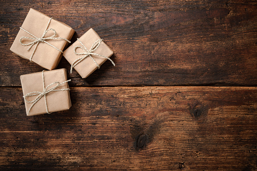 Gift boxes over dark wooden background