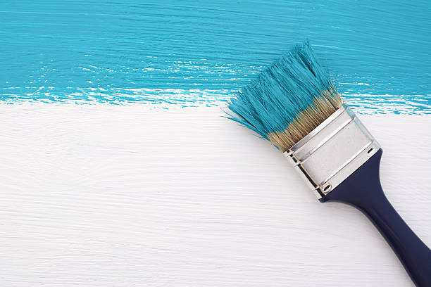 istock Stripe of turquoise paint with a paintbrush on white 491291920