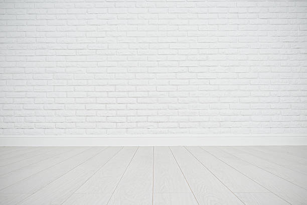 istock white blank brick wall and wooden floor 491293566