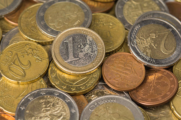 istock pile of coins, close up 491294058