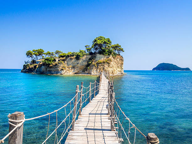 Cameo island, Zakinthos, on horizon Turtle island in Mediterranee Lounge island with hidden beach. Island in front of Zakinthos to be reach by footbridge. Small hidden paradise, local best keptt secret. ionian sea photos stock pictures, royalty-free photos & images